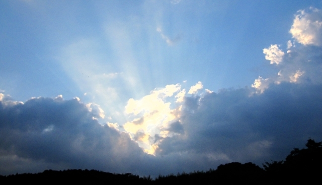 灰色の雲から見える青空のイメージ画像